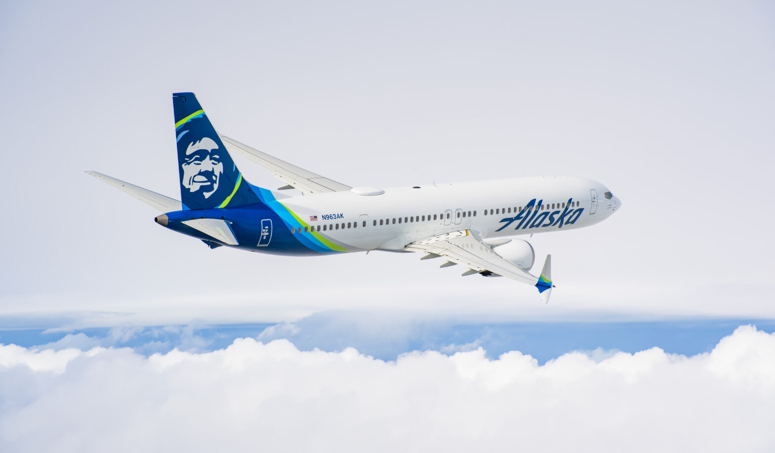 Alaska Airlines plane flies above the clouds